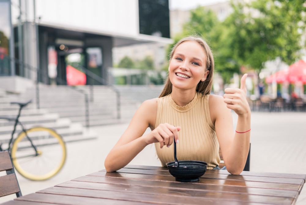 femme en terrasse avec le pouce en l'air