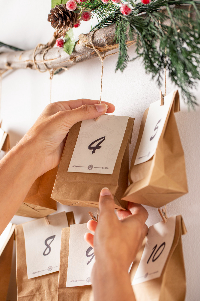 une femme accrochant un calendrier de l'avent artisanal