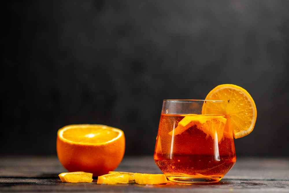 cocktail à coté d'une orange tranché