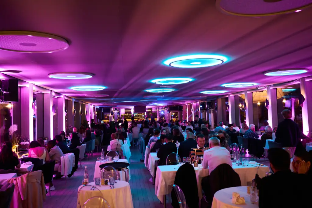 Salle de restaurant du Diamant Bleu à Paris avec ambiance festive et éclairages colorés